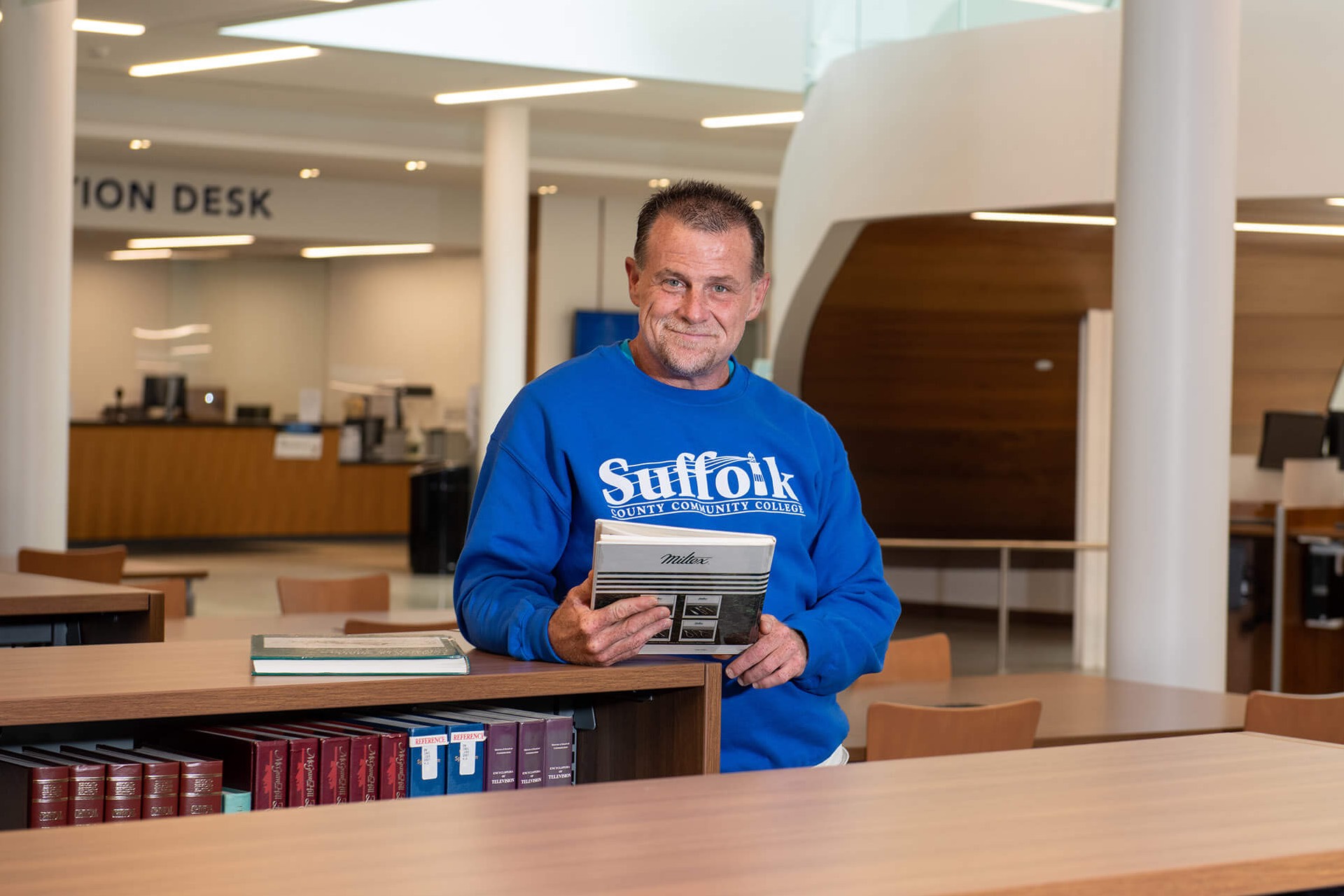 Adult 53 year-old male wearing a Suffolk sweatshirt.