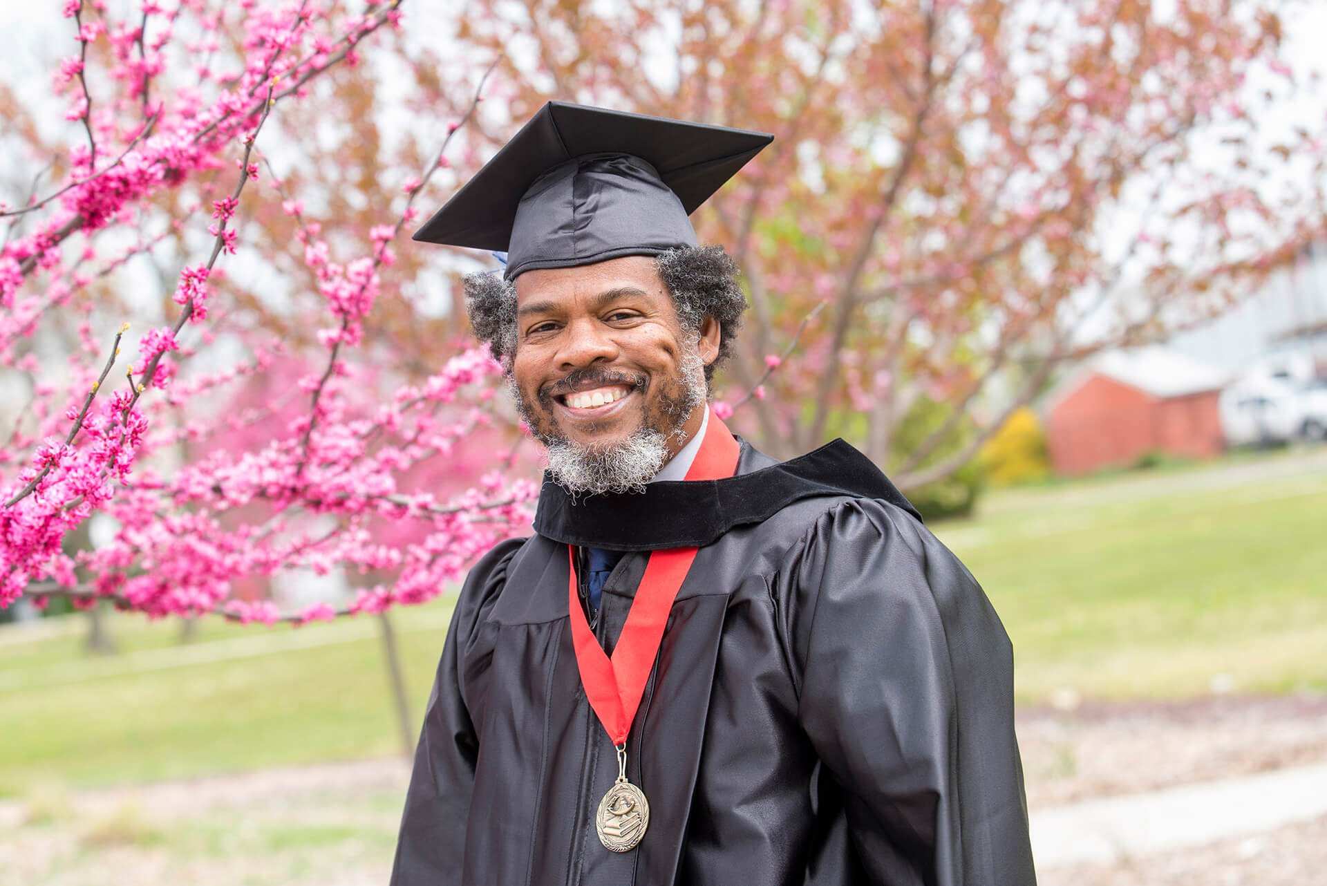 Male adult student smiling at graduation