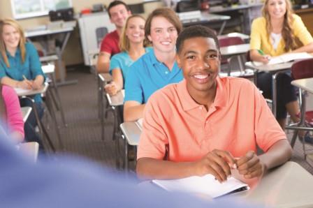 Student smiling sitting in a classroom