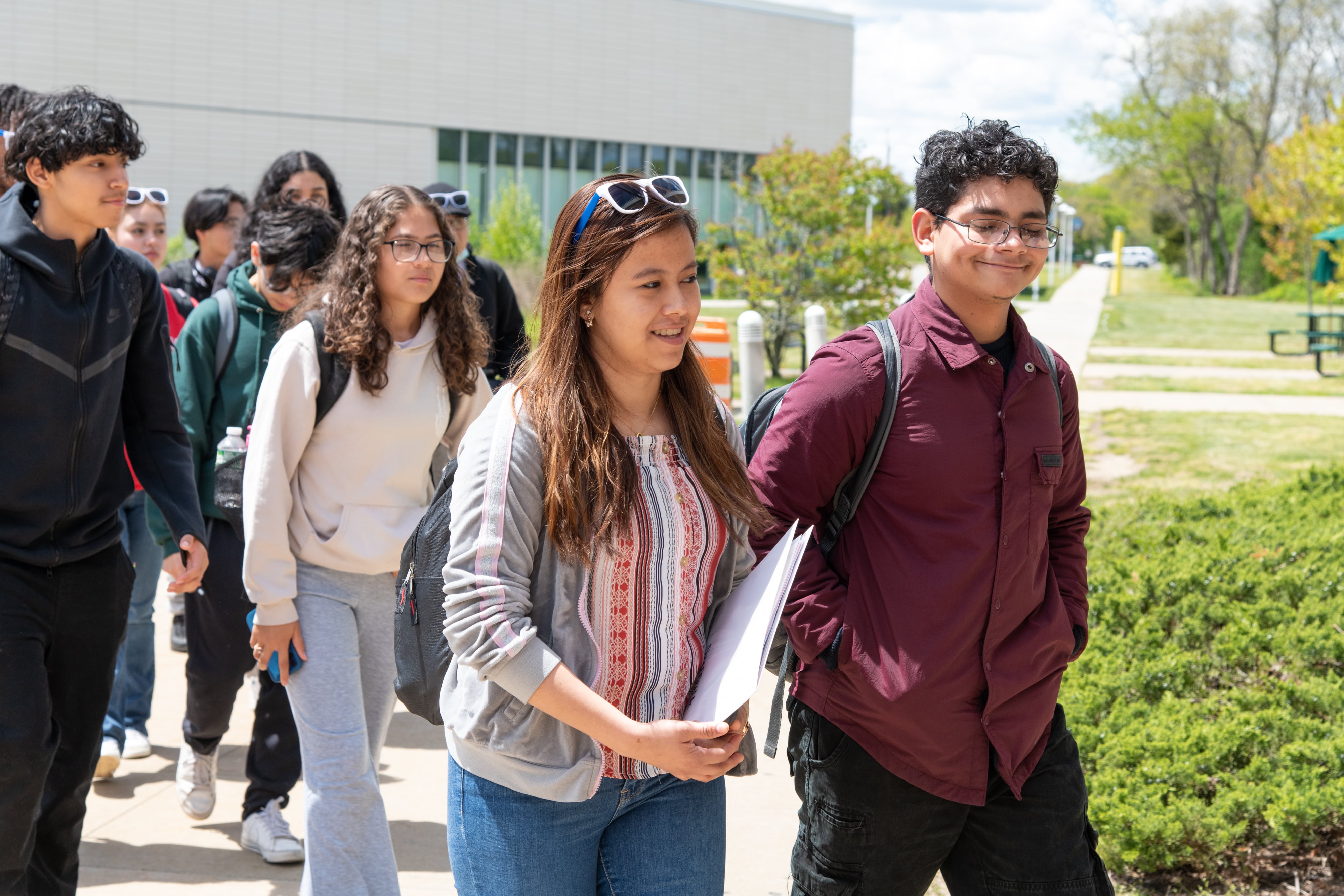 Group of students walking on the Michael J. Grant campus