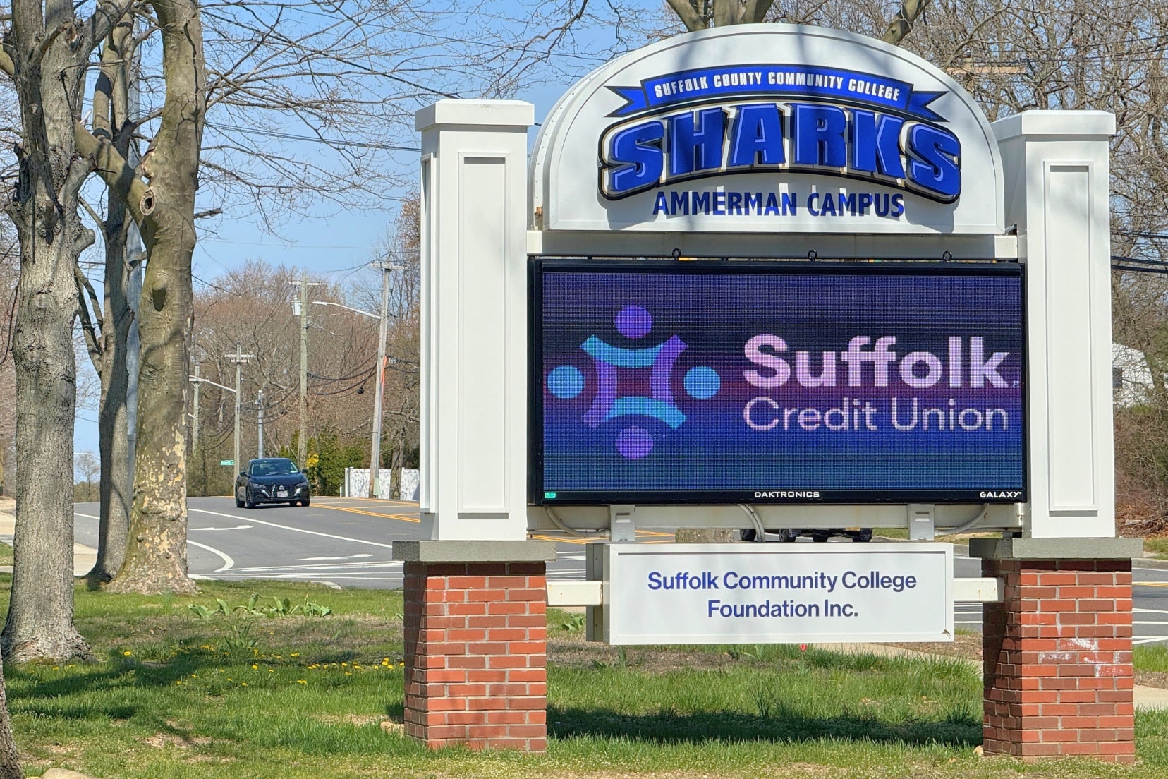 Outdoor Banner held by administrators and students.