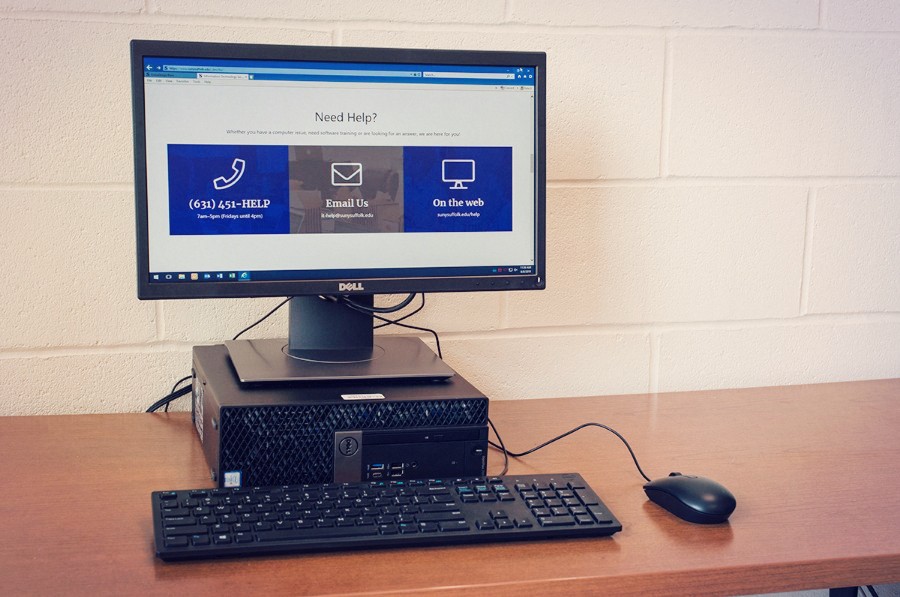 Laptop connected to an external monitor with the College website on screen.
