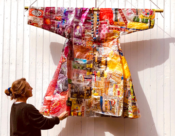 Artist Marta Baumiller’s over life-sized kimono, a type of royal robe that Baumiller created by ironing plastic packaging together into a fabric which she then sewed into a kimono.