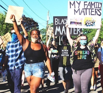 Germani Williams, at left, marches in Huntington earlier this month.