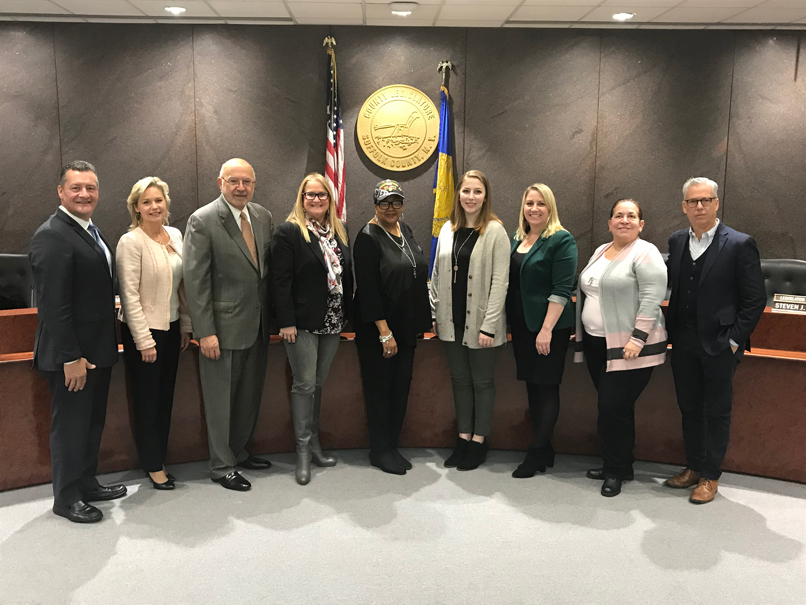College Director of Veteran’s Affairs Shannon O’Neill, third from right, was joined by Interim Suffolk County Community College President Louis Petrizzo, third from left, and Suffolk County Community College graduate and Airman at the 106th Air Rescue Wing Kathryn Patton, fourth from right. 