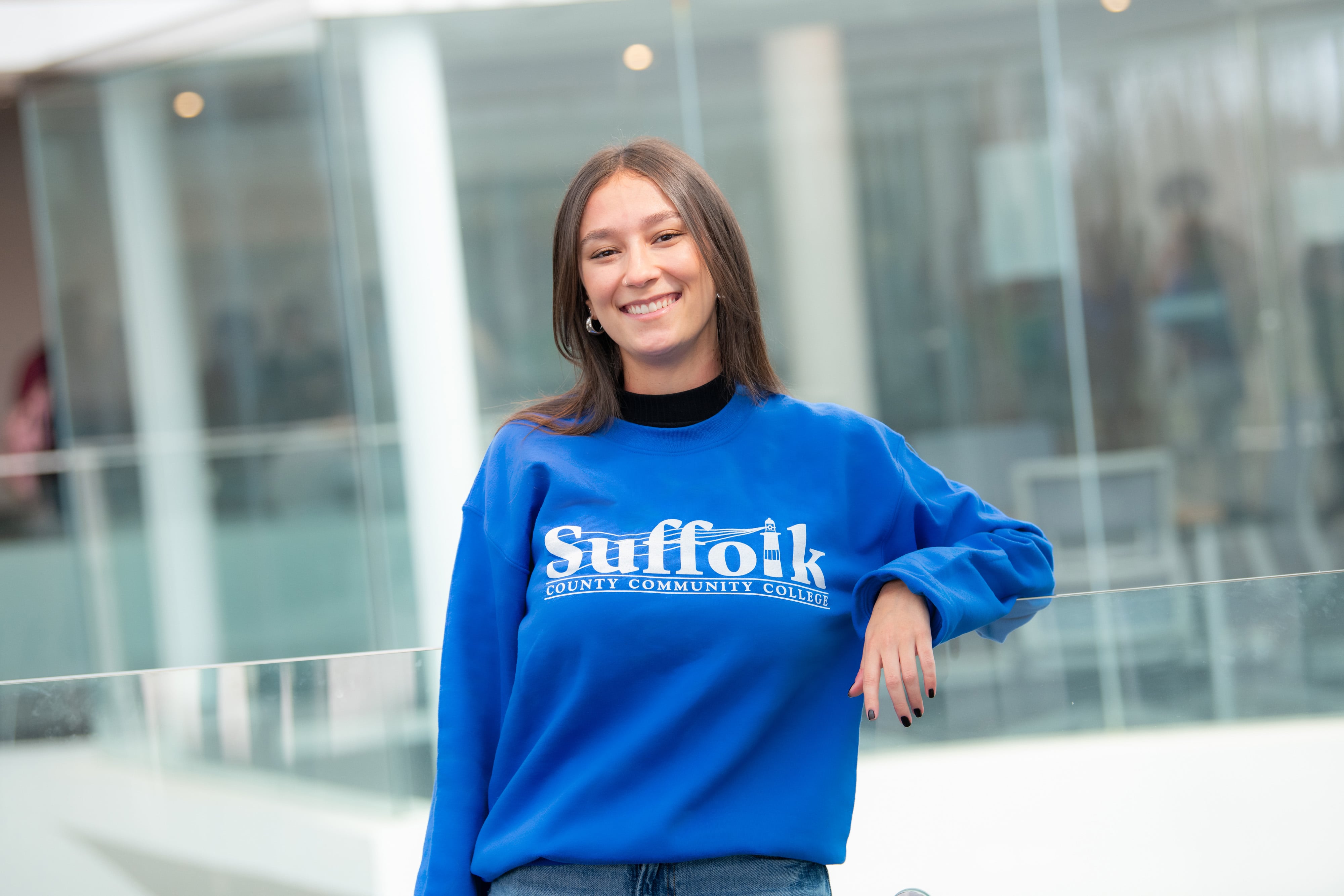 A student outside a building on college campus.
